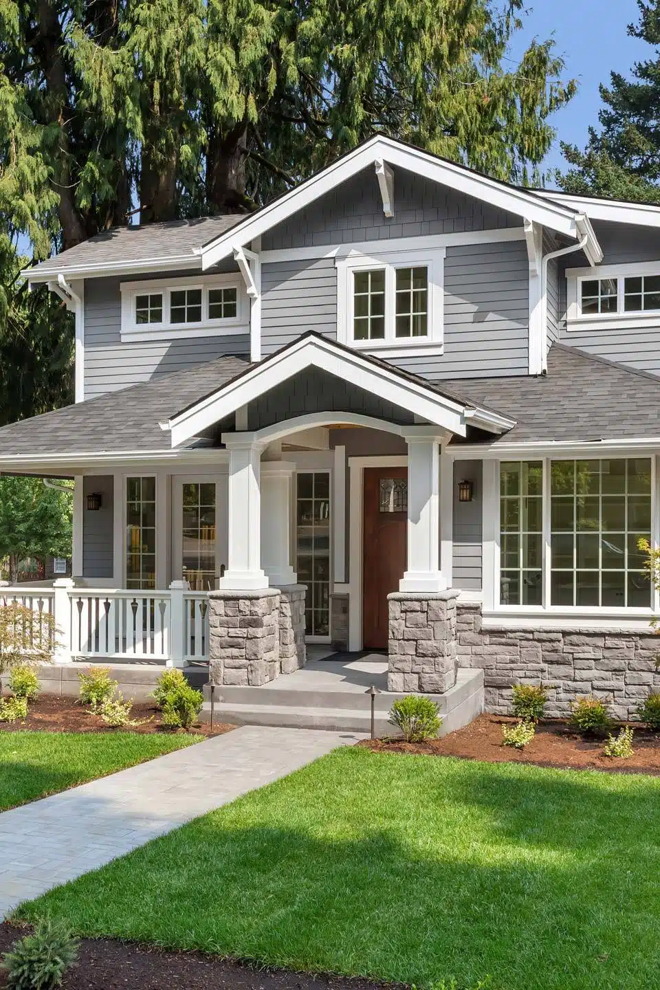 Two story house with gray siding and white trim